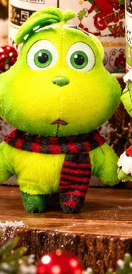 Cute green holiday figure with big eyes and winter scarf