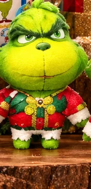Green Christmas collectible character with mischievous eyes and decorative outfit