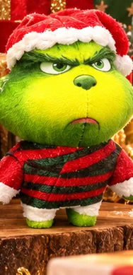 Grumpy green Christmas figure wearing a red-and-black striped sweater